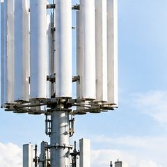 B16 wind turbine beside a telecom tower